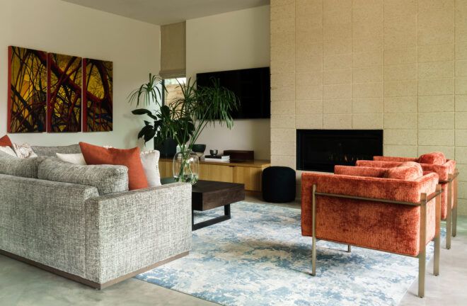 living room with gray sofa and dark orange chairs