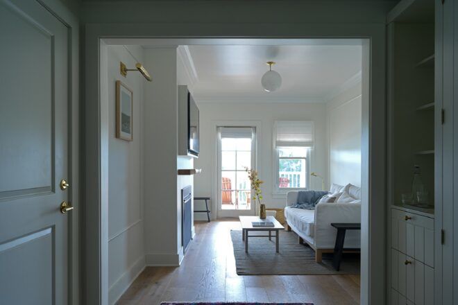 An entryway to a bedroom with white walls and accents.
