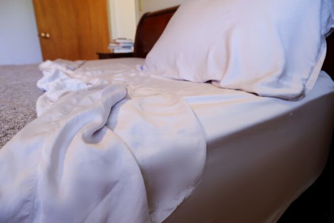 made bed with gray sheets