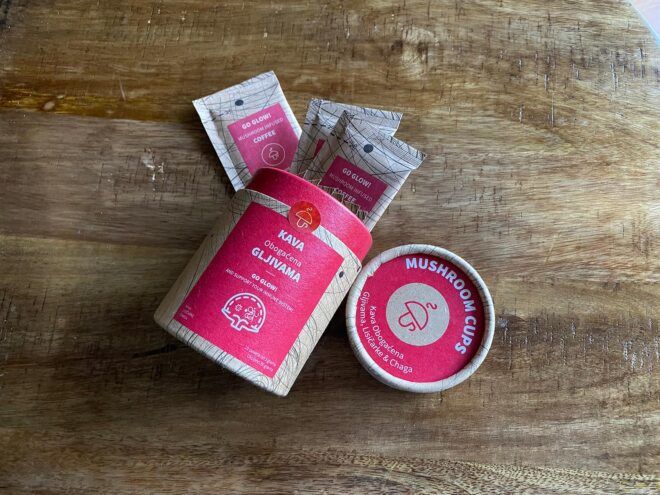 red and brown container with organic coffee packets spilling out