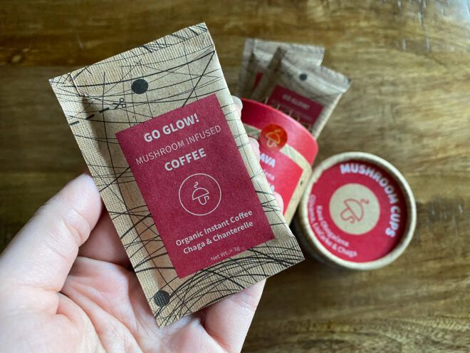 hand holding paper packet of single-serve coffee