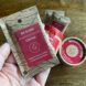 hand holding paper packet of single-serve coffee
