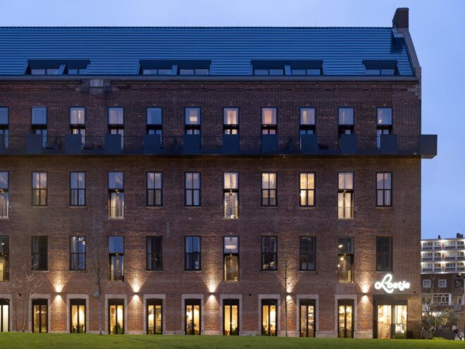 brick building lit with flood lights at dusk