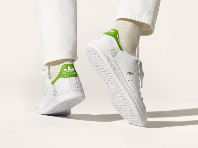 person wearing white and green adidas