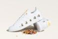 pile of shredded plastic next to adidas sneakers