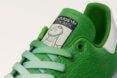 close-up of green sneaker with dinosaur on tongue of shoe