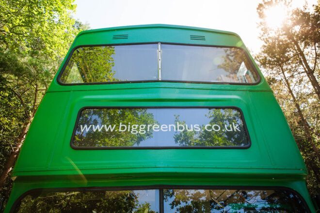 The front top of a large green bus, showing a sign reading "www.biggreenbus.co.uk."