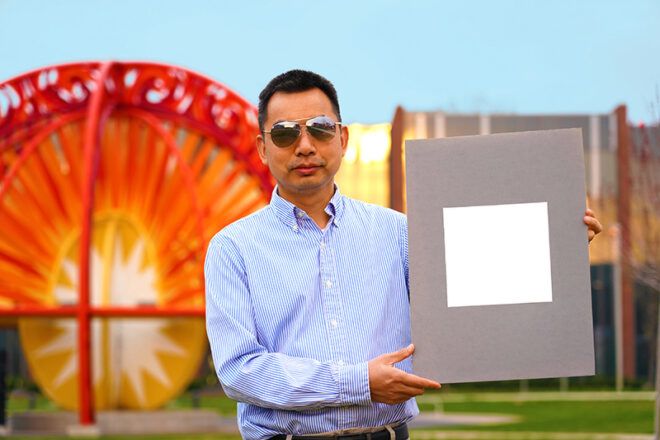 person holding board with bright white paint on it