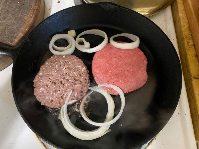Beyond Burger and Impossible Burger cooking in a cast iron skillet