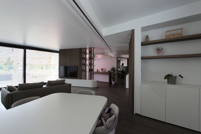 long white dining table near wall of bookshelves