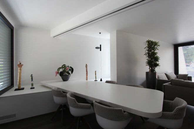 long white dining table near houseplant