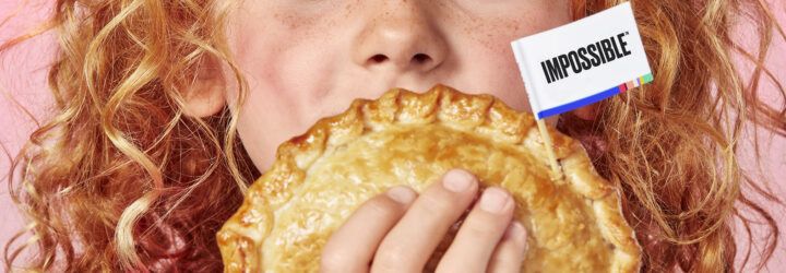 A close-up of a child holding an Impossible meat empanada.