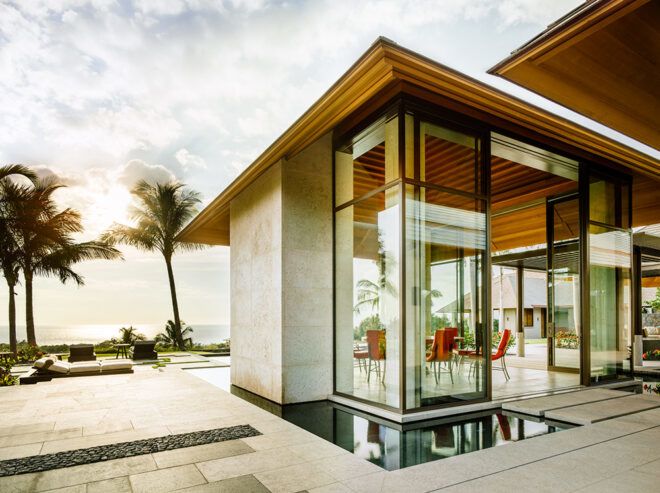 glass building with ocean in distance