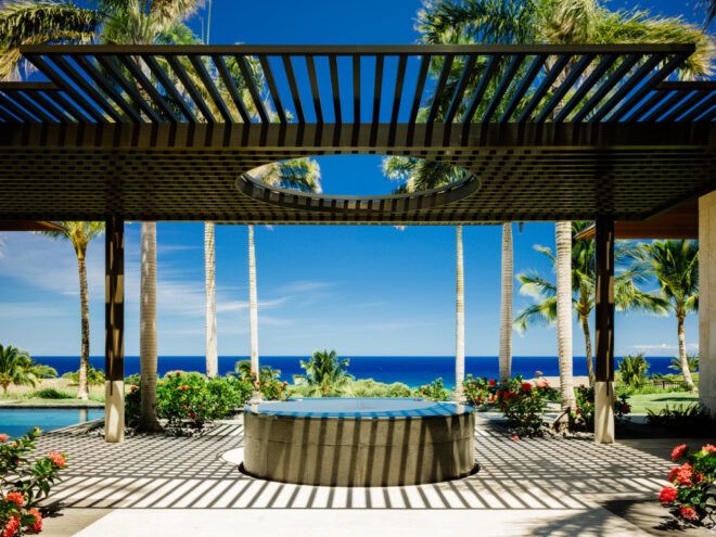 round hot tub beneath pergola