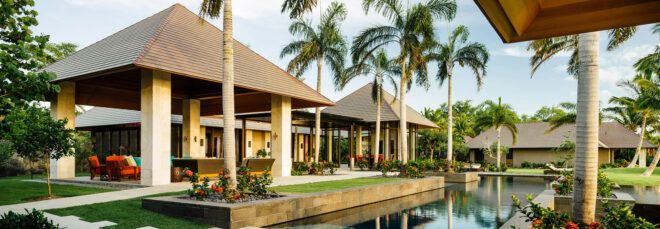 white pavilions with thatched roofs