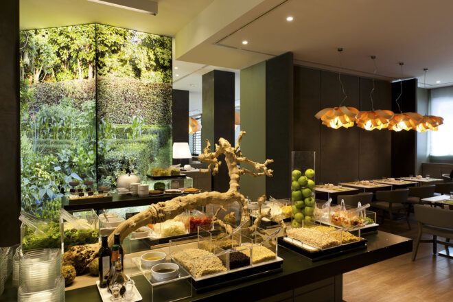 A green hotel lobby with art installations in a nature theme.