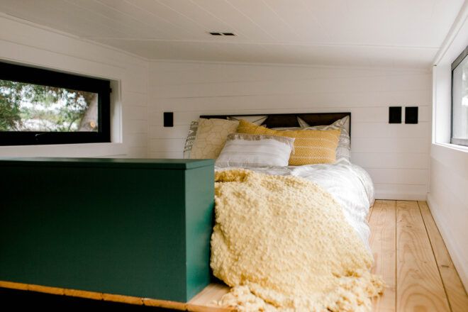 soft beige and white bed in a loft