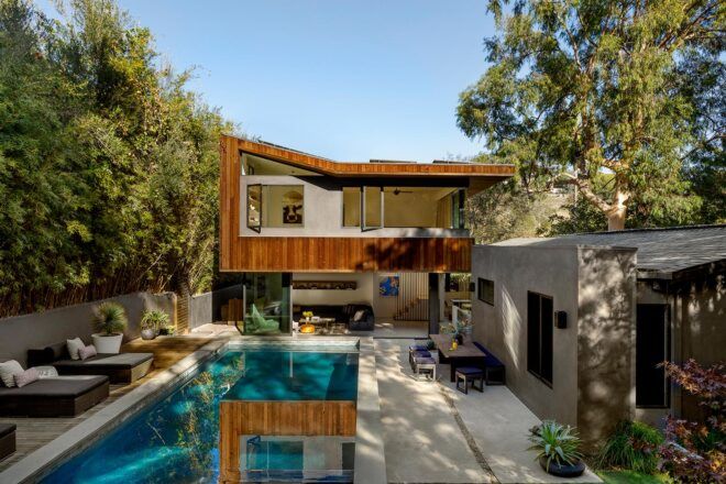 white and wood home with pool and patio