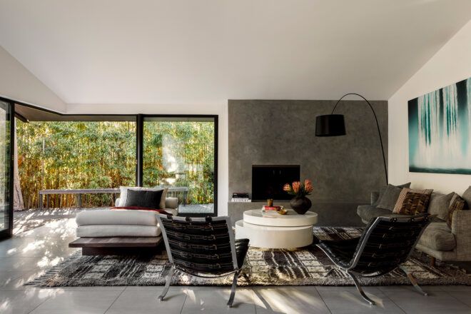 living area with concrete wall and gray furnishings