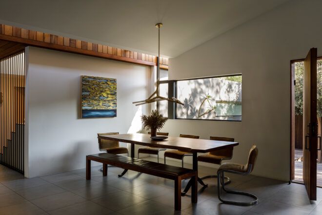 long wood dining table near narrow window