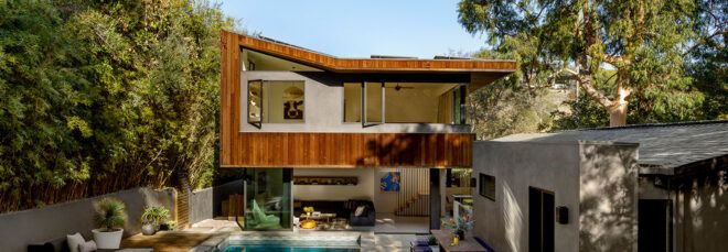 white and wood home with pool and patio