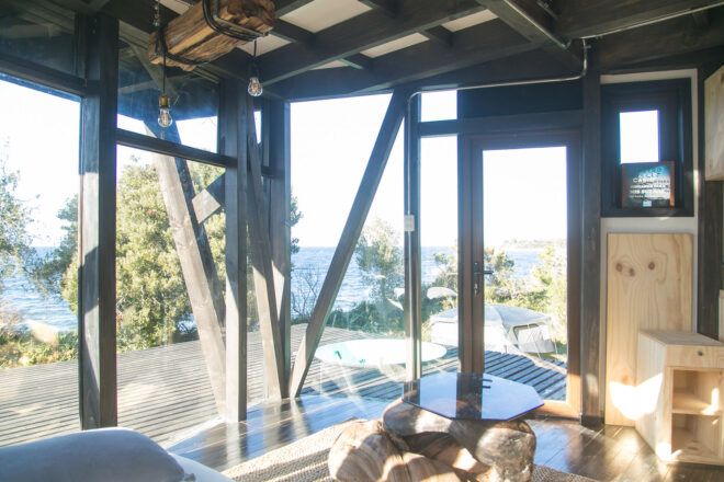 room with glass walls revealing forest views