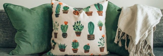 handmade throw pillows and throw blanket on gray sofa