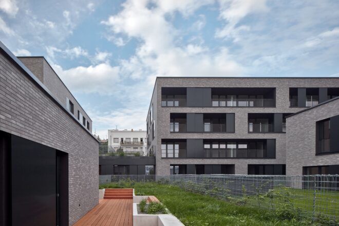gray buildings on a green-roofed base