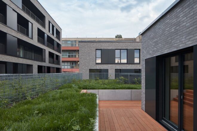 plant-filled courtyards between gray buildings