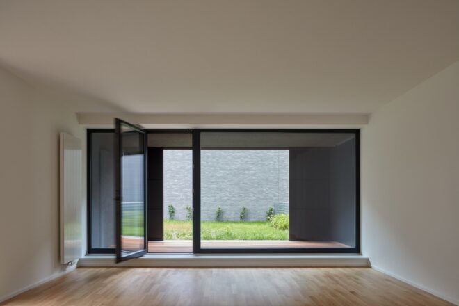 glass wall revealing forest views