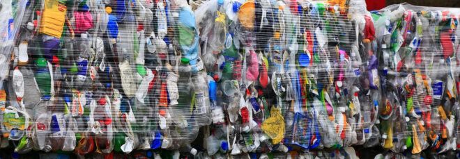 plastic bottles packed up and being hauled for recycling