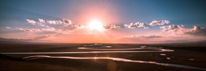Sun setting over a winding river