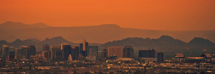 Phoenix, Arizona skyline under an orange, hazy sky