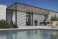 pool next to home with pergola