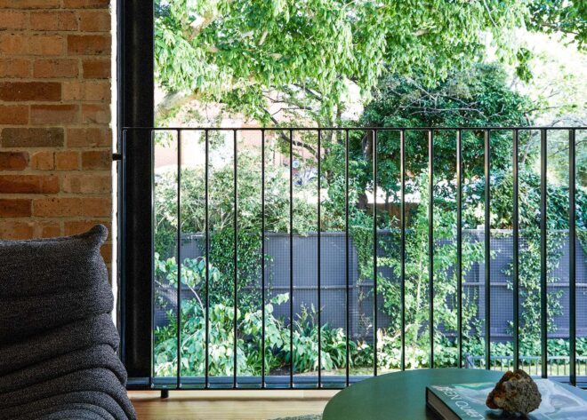 A large interior window looking out on a lush garden.