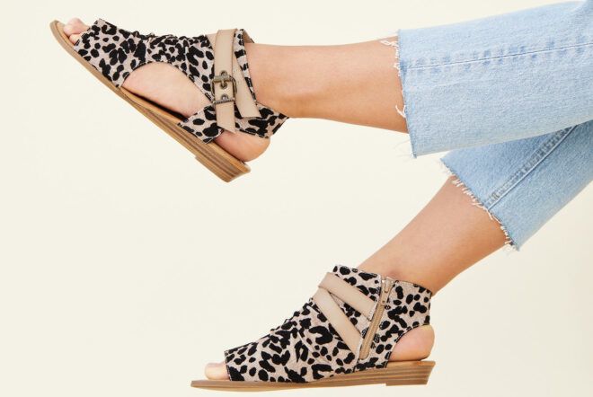 A pair of feet wearing Balla4Earth shoes in Sand Cat.