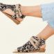 A pair of feet wearing Balla4Earth shoes in Sand Cat.