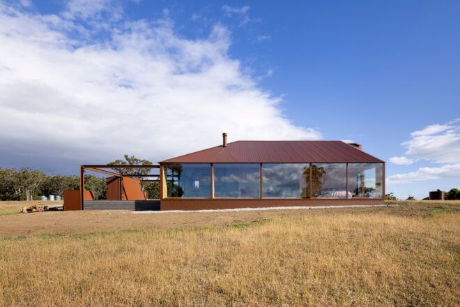 dark red and brown home with large windows