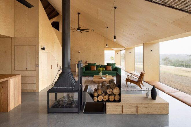 wood-lined living room with central fireplace
