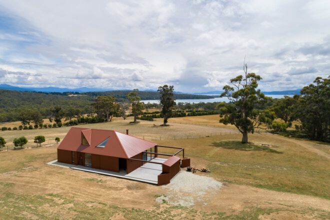 aerial view of dark red home on a farm