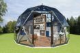 rendering of clear geodesic dome with living area inside