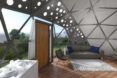 rendering of sofa near wood door in a geodesic dome