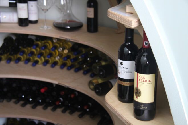 curved shelves full of wine bottles