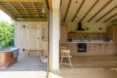 woo cabin with one wall open to outdoor patio