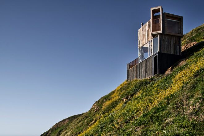 light and dark wood cabin on hillside