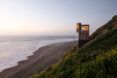 light and dark wood cabin overlooking the ocean