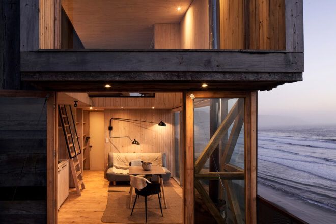 glass doors open to reveal minimal interior living room