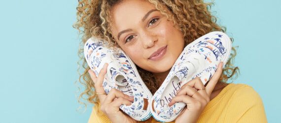 A person holding a pair of Marley4Earth Offwhite Summer Lovin shoes.