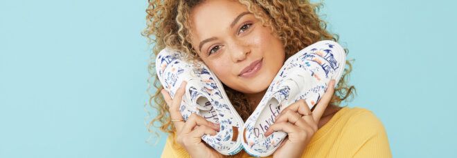 A person holding a pair of Marley4Earth Offwhite Summer Lovin shoes.