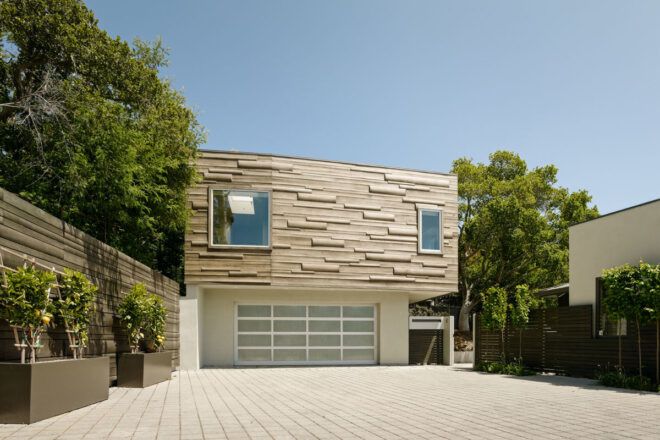 tan house with pillowed wood siding